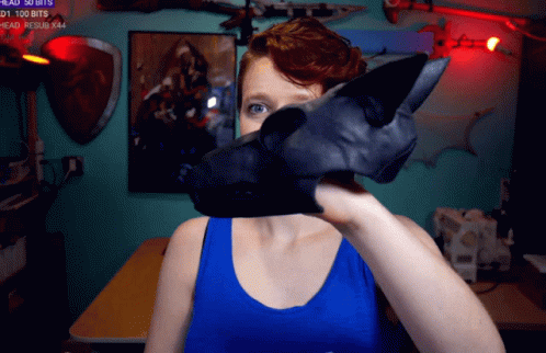 Woman In Blue Tank Top Holding Black Object GIF