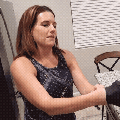 Woman In Blue Tank Top Holding Man's Hand GIF