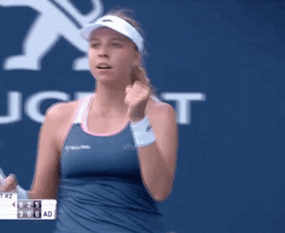 Woman In Blue Tank Top Holding Tennis Racket GIF