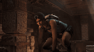 Woman In Blue Tank Top Kneeling In Front Of Egypt Pillar GIF