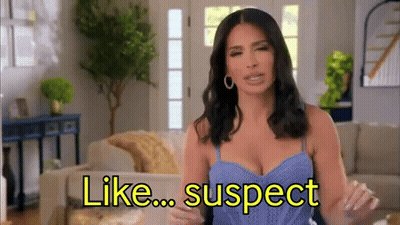 Woman In Blue Tank Top Sitting On Couch Saying Like Suspect GIF