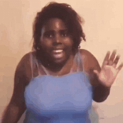 Woman In Blue Tank Top Smiling And Waving GIF