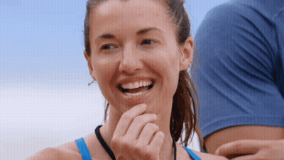 Woman In Blue Tank Top Smiling Hand To Chin GIF