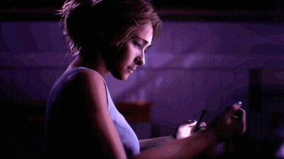 Woman In Blue Tank Top Using Cell Phone In Dark Room GIF