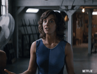 Woman In Blue Tank Top With Netflix Logo GIF