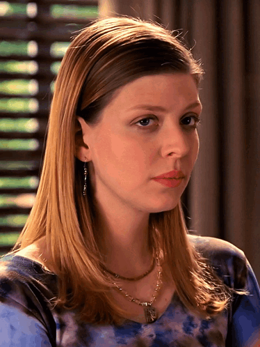 Woman In Blue Tie Dye Shirt And Necklace GIF