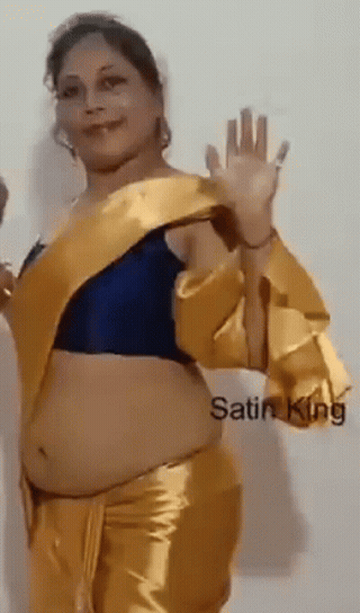 Woman In Blue Top And Gold Pants Waving GIF
