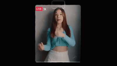 Woman In Blue Top And White Skirt Singing Live GIF