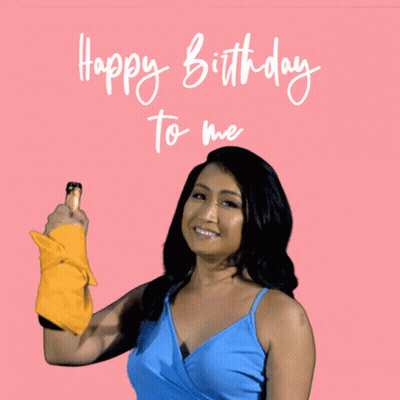 Woman In Blue Top Holding Yellow Towel Says Happy Birthday To Me GIF