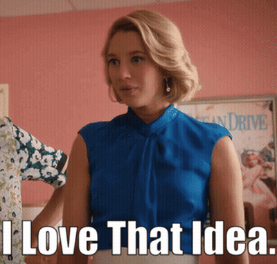 Woman In Blue Top Standing In Front Of I Love That Idea Sign GIF