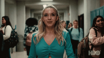 Woman In Blue Top Walking Down Hallway With HBO Logo GIF