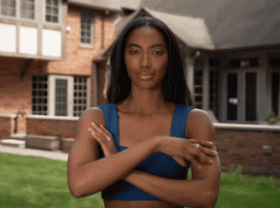 Woman In Blue Top With Arms Crossed GIF