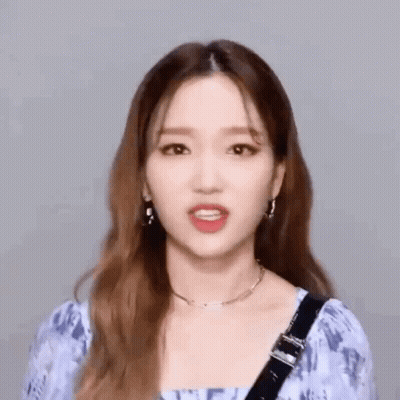 Woman In Blue Top With Earrings GIF