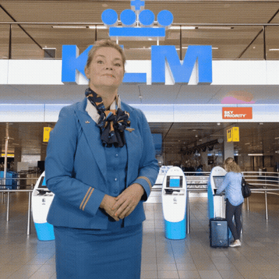Woman In Blue Uniform At Sky Priority Sign GIF