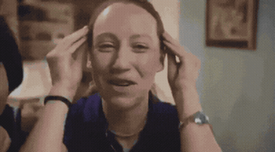 Woman In Blue Watch Holding Head GIF