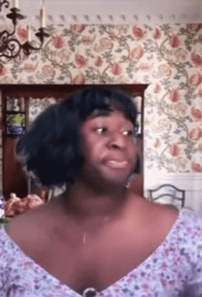 Woman In Blue Wig And Floral Top GIF