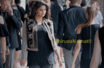 Woman In Bomber Jacket Walking Through Crowd Saying Thiruda N Chat GIF