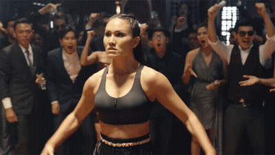 Woman In Boxing Sports Bra In Front Of Crowd GIF