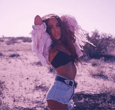 Woman In Bra And Shorts Standing In Field GIF