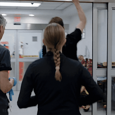 Woman In Braided Ponytail Standing In Front Of Sliding Glass Door Saying Mat GIF
