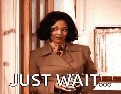 Woman In Brown Coat Holding Wine Saying Just Wait GIF