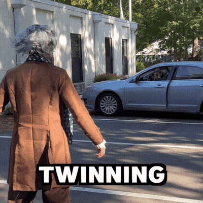 Woman In Brown Coat Walking Toward Silver Car Twinning GIF
