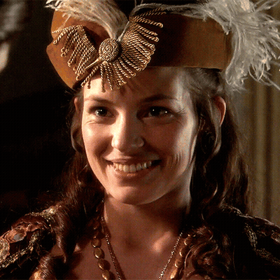 Woman In Brown Hat With Feathers GIF