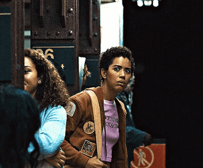 Woman In Brown Jacket And Purple Shirt Saying Aventura GIF