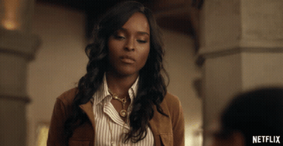 Woman In Brown Jacket And Striped Shirt Netflix Ad GIF