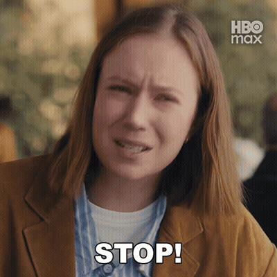 Woman In Brown Jacket Says Stop In Front Of HBO Max Logo GIF