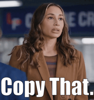Woman In Brown Jacket With Sign Copy That GIF