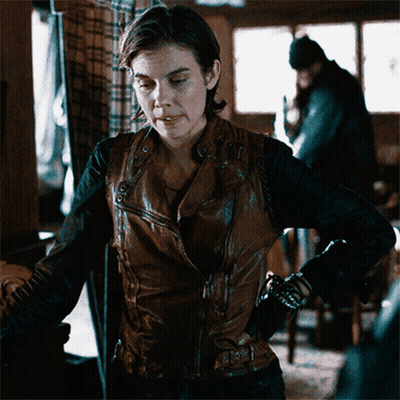 Woman In Brown Leather Jacket In Dark Room GIF
