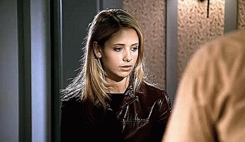 Woman In Brown Leather Jacket Next To Man In Brown Shirt GIF