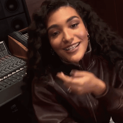 Woman In Brown Leather Jacket Smiling And Clapping GIF