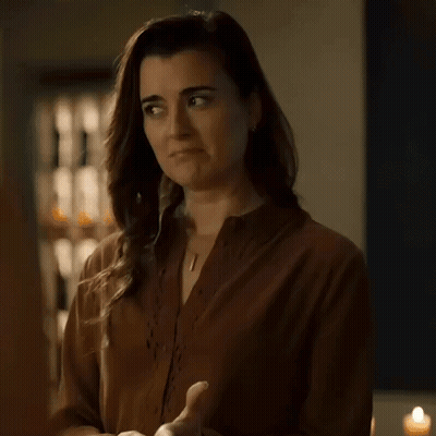 Woman In Brown Shirt Making No Deal Gesture GIF