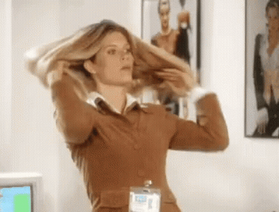 Woman In Brown Suit With Name Tag Saying Elizabeth GIF