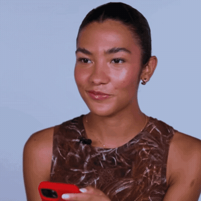 Woman In Brown Tank Top Holding Red Cell Phone GIF