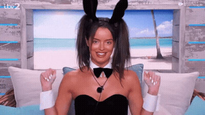 Woman In Bunny Ears And Bow Tie On Couch GIF