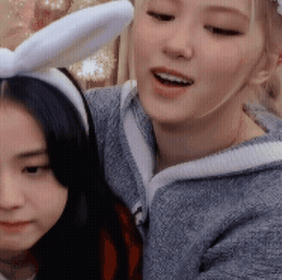 Woman In Bunny Ears Beside Another Woman GIF