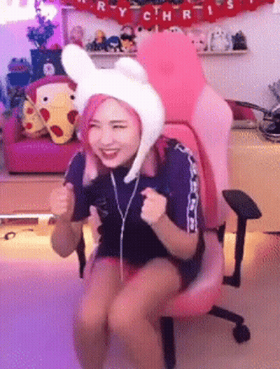 Woman In Bunny Hat Sitting In Pink Chair GIF
