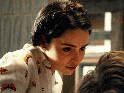 Woman In Butterfly Shirt Looking Down GIF
