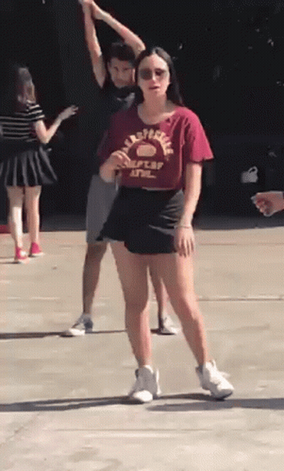 Woman In California State Shirt On Sidewalk With Others GIF