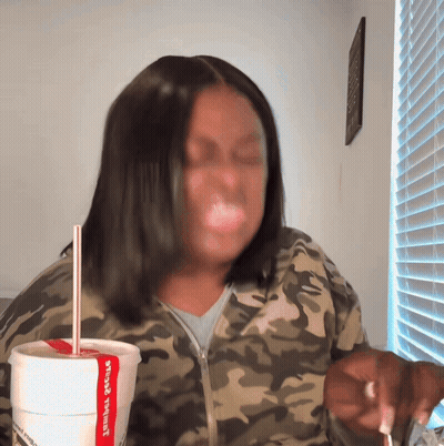 Woman In Camo Jacket Drinking Jambalaya Cup GIF