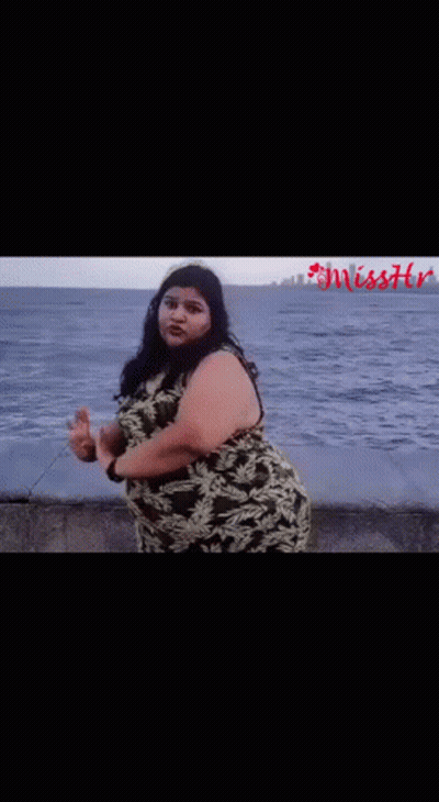 Woman In Camouflage Dress On Beach Near Ocean GIF