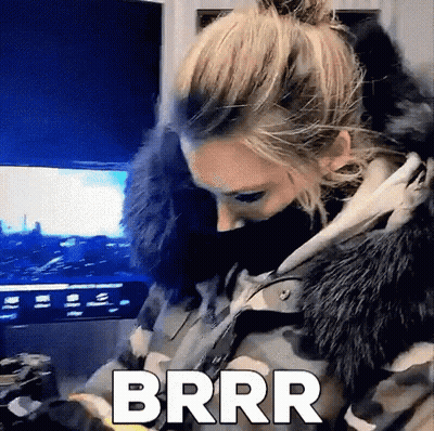 Woman In Camouflage Jacket And Fur Hood Sitting In Front Of TV GIF