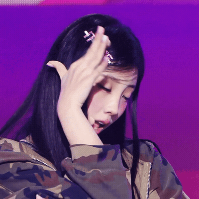 Woman In Camouflage Jacket Hand To Head GIF