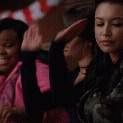 Woman In Camouflage Jacket Sitting Next To Another Woman GIF