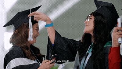 Woman In Cap And Gown Says Proud GIF