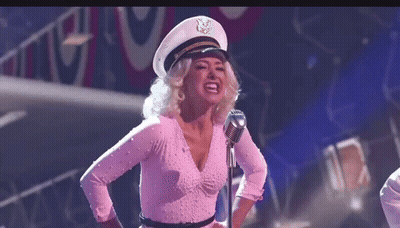 Woman In Captain Hat Singing Into Microphone GIF