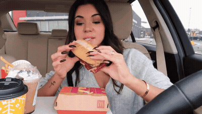 Woman In Car Eating McDonald's Sandwich GIF